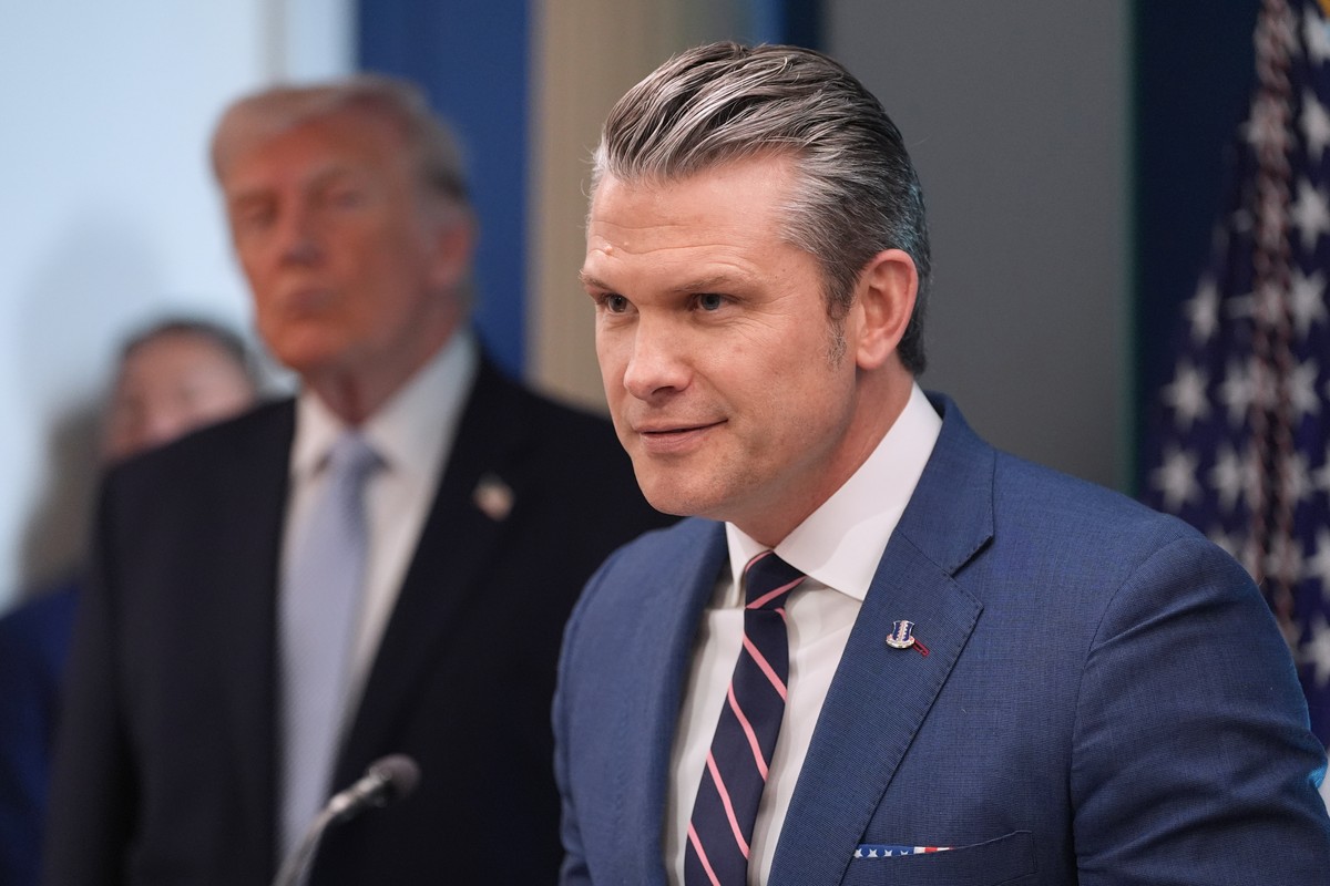 Defense Secretary Pete Hegseth speaks with reporters in the James Brady Press Briefing Room at the White House, Monday, April 6, 2026, in Washington, as President Donald Trump looks on. (AP Photo/Alex ...