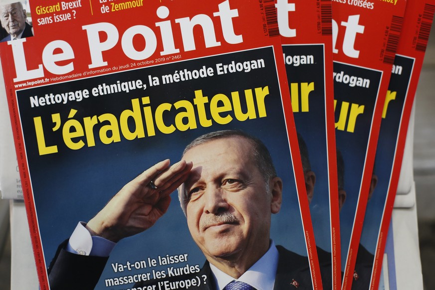 The cover of Le Point, a French weekly political magazine, featuring Turkish President Recep Tayyip Erdogan and the headline &quot;The eradicator&quot; is on display in a newsstands, in Paris, Friday, ...
