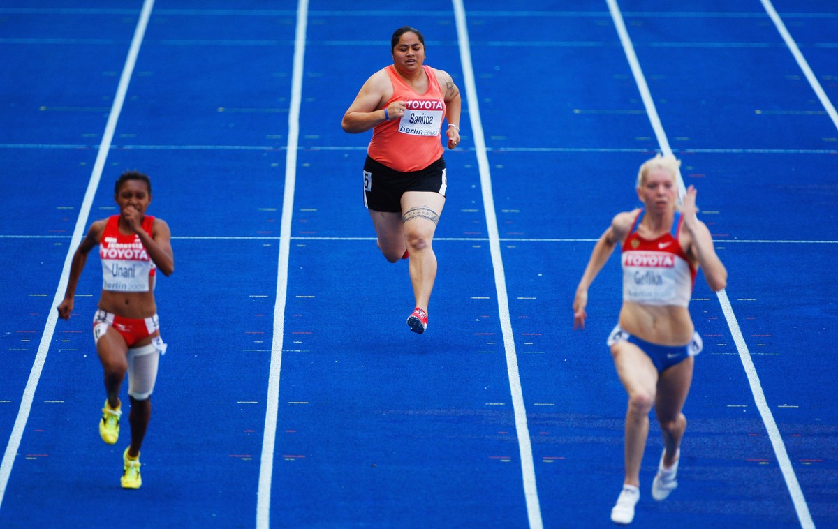 BERLIN - AUGUST 16: Savannah Sanitoa of American Samoa competes in the women's 100 Metres Heats during day two of the 12th IAAF World Athletics Championships at the Olympic Stadium on August 16,  ...