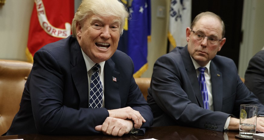 National Fraternal Order of Police President Chuck Canterbury listens at right as President Donald Trump speaks during a meeting with the Fraternal Order of Police, Tuesday, March 28, 2017, in the Roo ...