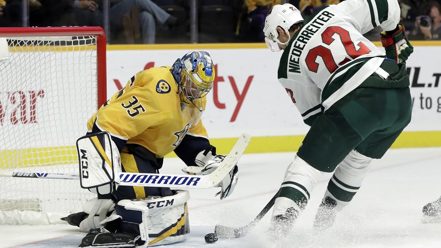 Nashville Predators goaltender Pekka Rinne (35), of Finland, blocks a shot by Minnesota Wild right wing Nino Niederreiter (22), of Switzerland, in the third period of an NHL hockey game Monday, Oct. 1 ...