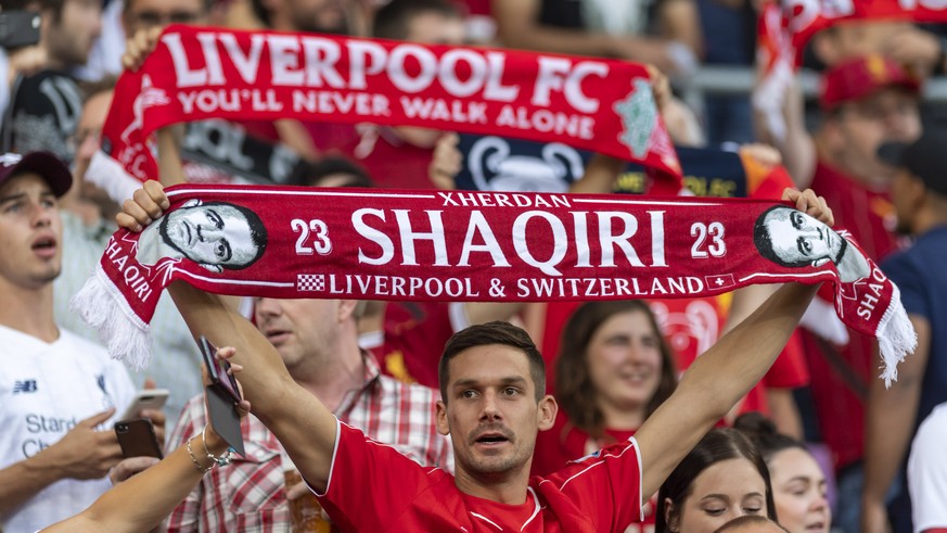 A fan shows a banner with the player Xherdan Shaqiri, during a friendly soccer match between Liverpool FC and French Olympique Lyonnais at the Stade de Geneve stadium, in Geneva, Switzerland, Wednesda ...