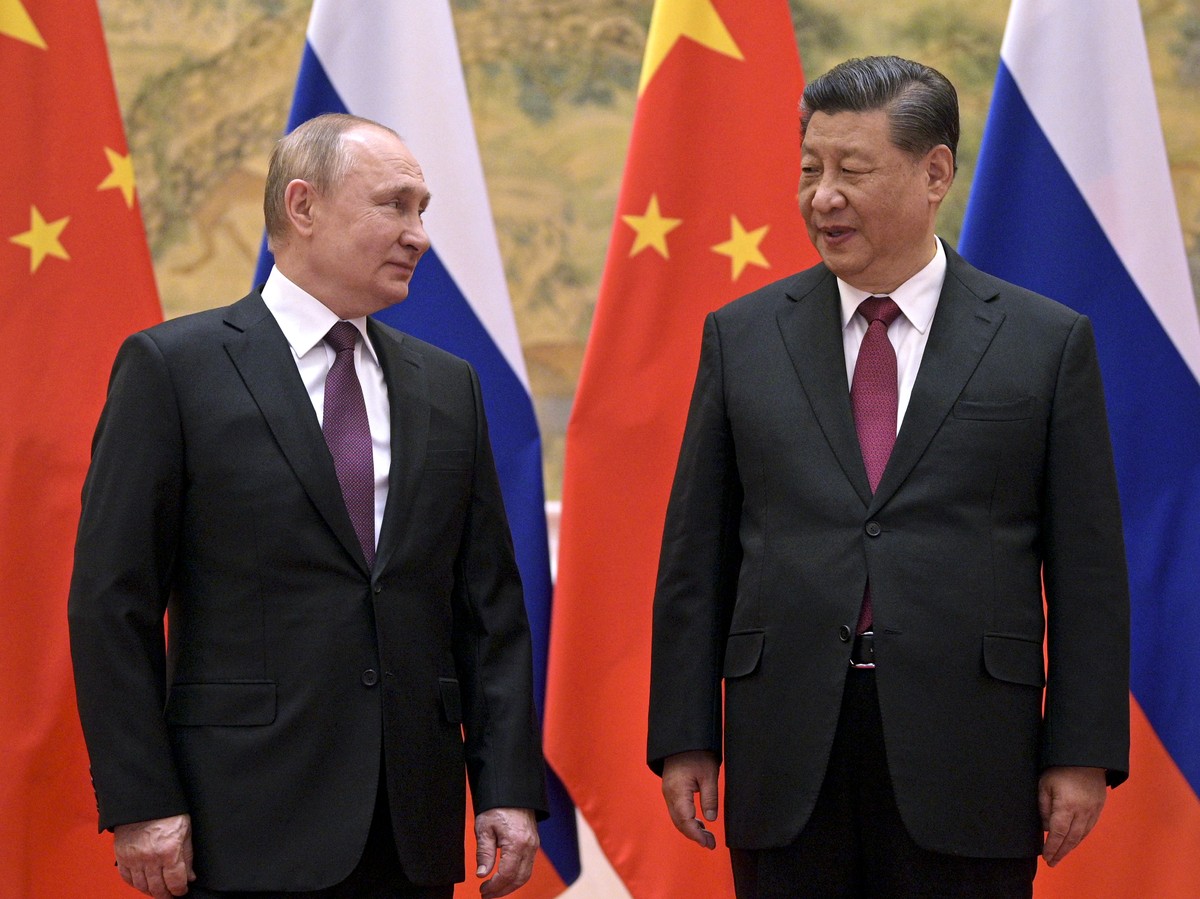 Chinese President Xi Jinping, right, and Russian President Vladimir Putin talk to each other during their meeting in Beijing, China, Friday, Feb. 4, 2022. Putin on Friday arrived in Beijing for the op ...