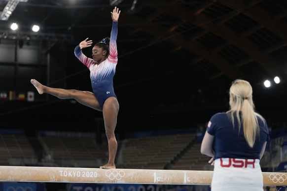 Simone Biles, of the United States, warms up prior to the artistic gymnastics balance beam final at the 2020 Summer Olympics, Tuesday, Aug. 3, 2021, in Tokyo, Japan. (AP Photo/Ashley Landis)