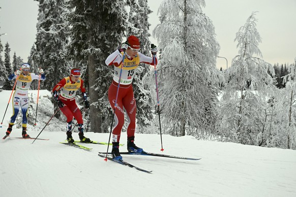 Nadine Faehndrich of Swizerland, right, and Ingvild Flugstad Oesterberg of Norway, center, and Emma Ribom of Sweden competes during the ladies' cross-country skiing 20km pursuit freestyle competition  ...