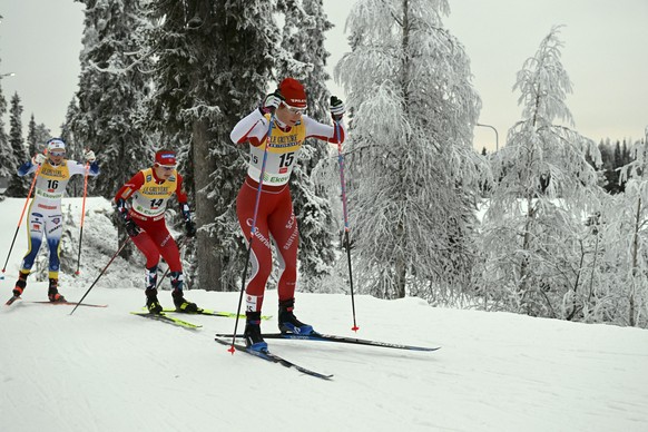 Nadine Faehndrich of Swizerland, right, and Ingvild Flugstad Oesterberg of Norway, center, and Emma Ribom of Sweden competes during the ladies' cross-country skiing 20km pursuit freestyle competition ...