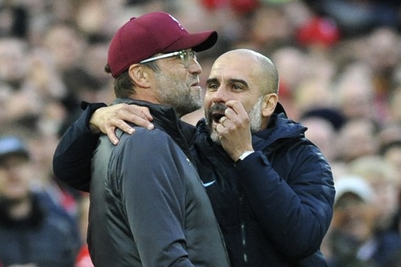 Manchester City manager Josep Guardiola, right, and Liverpool manager Juergen Klopp talk during the English Premier League soccer match between Liverpool and Manchester City at Anfield stadium in Live ...