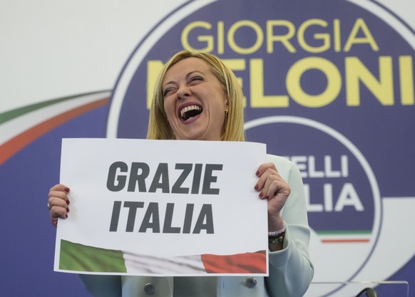 Far-Right party Brothers of Italy's leader Giorgia Meloni shows a placard reading in Italian &quot;Thank you Italy&quot; at her party's electoral headquarters in Rome, early Monday, Sept. 26, 2022. It ...