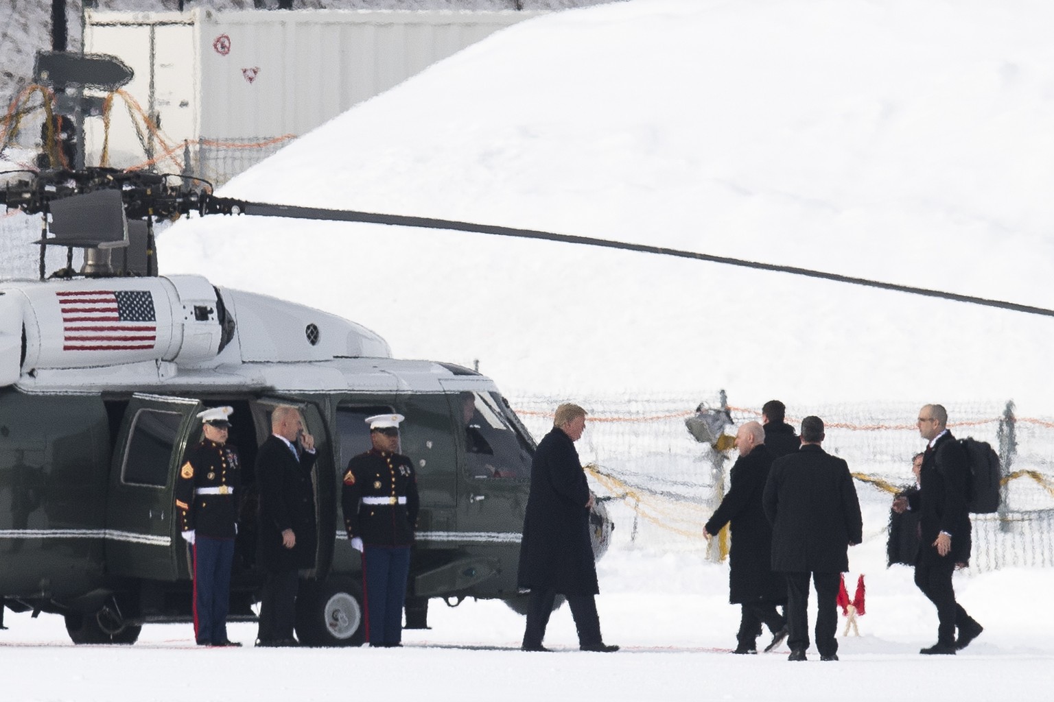 US President Donald Trump, center, leaves Marine One as he arrives for the annual meeting of the World Economic Forum, WEF, in Davos, Switzerland, Thursday, Jan. 25, 2018. (Gian Ehrenzeller/Keystone v ...