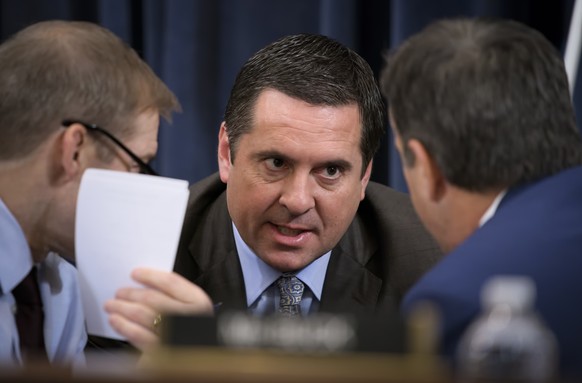 FILE - Rep. Devin Nunes, R-Calif, the then ranking member of the House Intelligence Committee, center, talks with Rep. Jim Jordan, R-Ohio, left and Rep. John Ratcliffe, R-Texas, during a break in a th ...