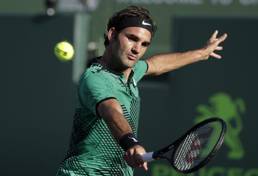 Roger Federer, of Switzerland, hits a return to Roberto Bautista Agut, of Spain, during the Miami Open tennis tournament, Tuesday, March 28, 2017, in Key Biscayne, Fla. (AP Photo/Lynne Sladky)