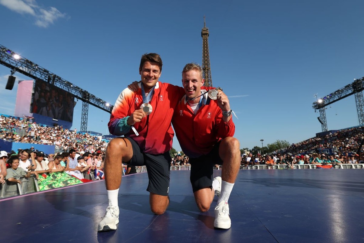 PARIS, FRANCE - AUGUST 06: Men's Coxless Pair bronze medalists Andrin Gulich and Roman Roeoesl of Team Switzerland pose for a photo with their medals at Champions Park on day eleven of the Olympi ...