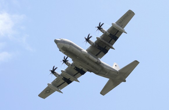 epa06080337 (FILE) - A US Navy KC-130 Hercules flies over Futenma second elementary school, where Japanese Prime Minister Yukio Hatoyama visits the school to inspect and talks with residents for a rel ...