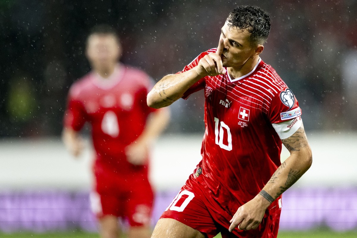 Switzerland's midfielder Granit Xhaka celebrates scoring the 2-0 goal during the UEFA Euro 2024 qualifying group I soccer match between Switzerland and Andorra at the Stade de Tourbillon stadium, ...