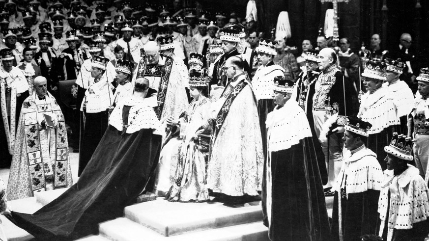 FILE - Britain&#039;s Prince Philip, the Duke of Edinburgh, kneeling, places his hands between those of Queen Elizabeth II, his wife, as he swears homage, during the Queen&#039;s Coronation ceremony a ...