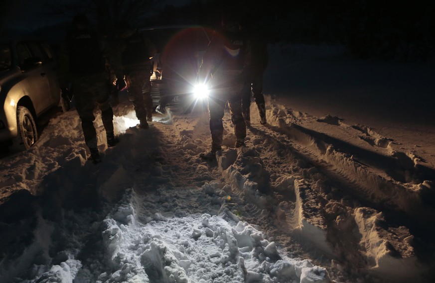Bosnian police return from chasing a suspected serial killer in the village of Medvjedice 30 kms south of Sarajevo, Bosnia, Tuesday, Feb. 12, 2019. Bosnia police on Tuesday shot and killed the country ...