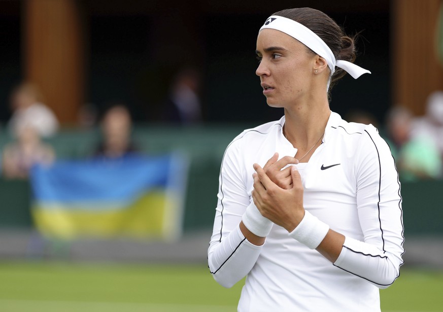 Ukraine&#039;s Anhelina Kalinina pauses as she plays against Hungary&#039;s Anna Bondar during a women&#039;s singles first round match on day one of the Wimbledon tennis championships in London, Mond ...