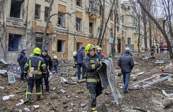 epa10448645 Ukrainian rescuers work at the site of a damaged residential building following a missile strike, in Kharkiv, northeastern Ukraine, 05 February 2023, amid Russia's invasion. At least four  ...
