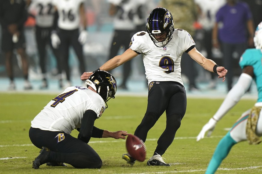 Baltimore Ravens kicker Justin Tucker (9) kicks a field goal as punter Sam Koch (4) holds, during the first half of an NFL football game against the Miami Dolphins, Thursday, Nov. 11, 2021, in Miami G ...