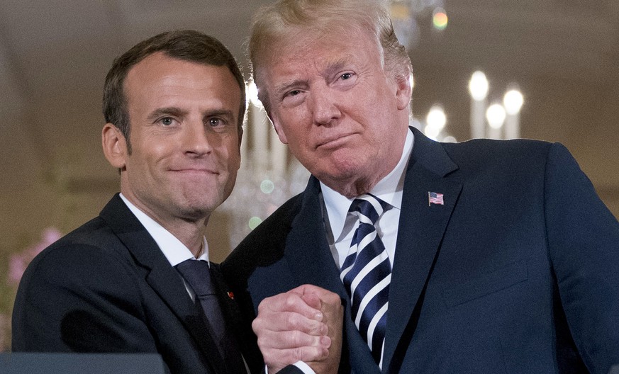 President Donald Trump and French President Emmanuel Macron embrace at the conclusion of a news conference in the East Room of the White House in Washington, Tuesday, April 24, 2018. (AP Photo/Andrew  ...