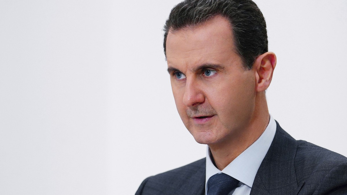 FILE - In this photo released on Nov. 9, 2019 by the Syrian official news agency SANA, Syrian President Bashar Assad speaks in Damascus, Syria. Security guards from the Syrian president's Baath p ...