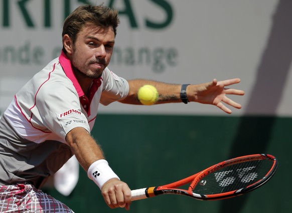 Switzerland&#039;s Stan Wawrinka returns the ball to Turkey&#039;s Marsel Ilhan during their first round match of the French Open tennis tournament at the Roland Garros stadium, Sunday, May 24, 2015 i ...