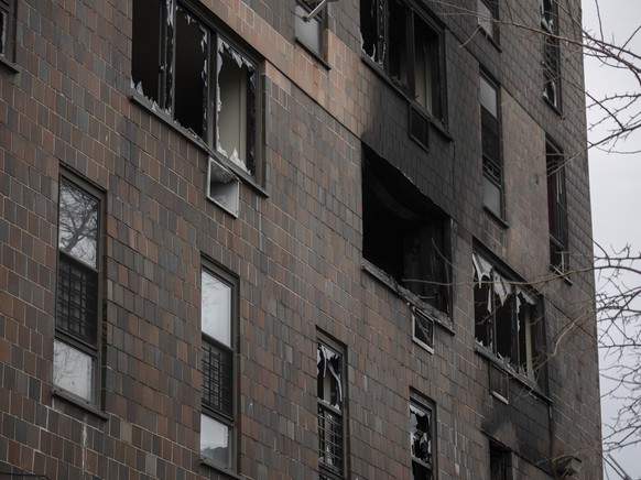 Broken windows are seen at the burned apartment building in the Bronx on Sunday, Jan. 9, 2022, in New York. The majority of victims were suffering from severe smoke inhalation, FDNY Commissioner Danie ...