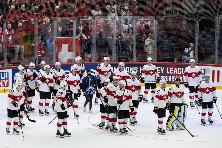 epa09963546 Swiss players celebrate after winning the IIHF Ice Hockey World Championship group A preliminary round match between Switzerland and Canada in Helsinki, Finland, 21 May 2022. EPA/PETER SCH ...