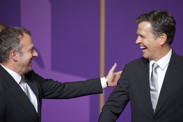 Germany&#039;s coach Hansi Flick, left, and national team director Oliver Bierhoff react as they arrive for the 2022 soccer World Cup draw at the Doha Exhibition and Convention Center in Doha, Qatar,  ...