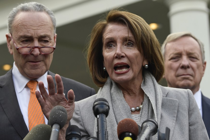 House Speaker Nancy Pelosi of Calif., center, speaks as she stands next to Senate Minority Leader Sen. Chuck Schumer of N.Y., left, and Sen. Dick Durbin, D-Ill., right, following their meeting with Pr ...