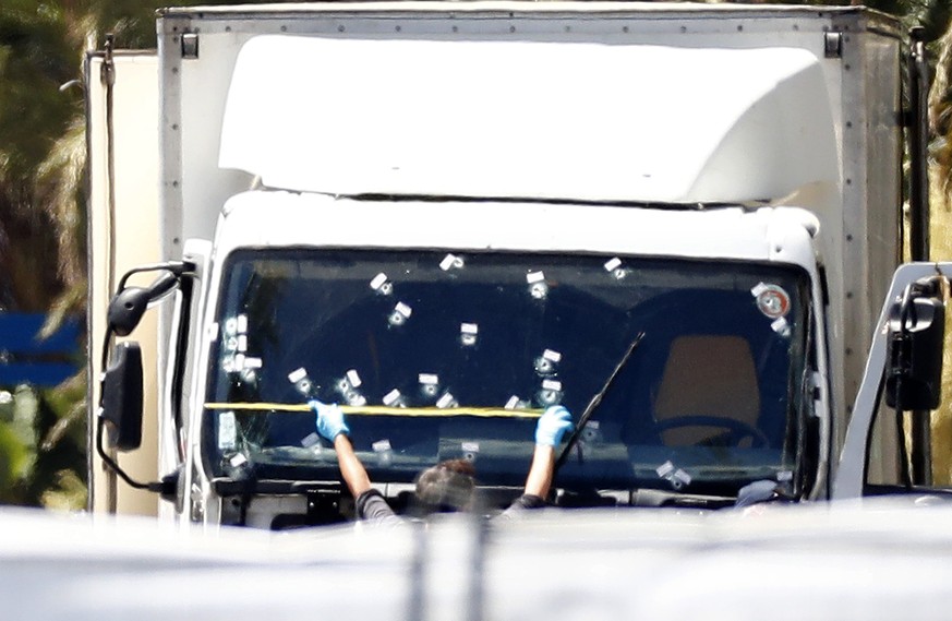 epa05426111 Crime scene detective works on the truck that drove into the crowd during Bastille Day celebrations in Nice, France, July 15, 2016. The French government announces a three-day national ...