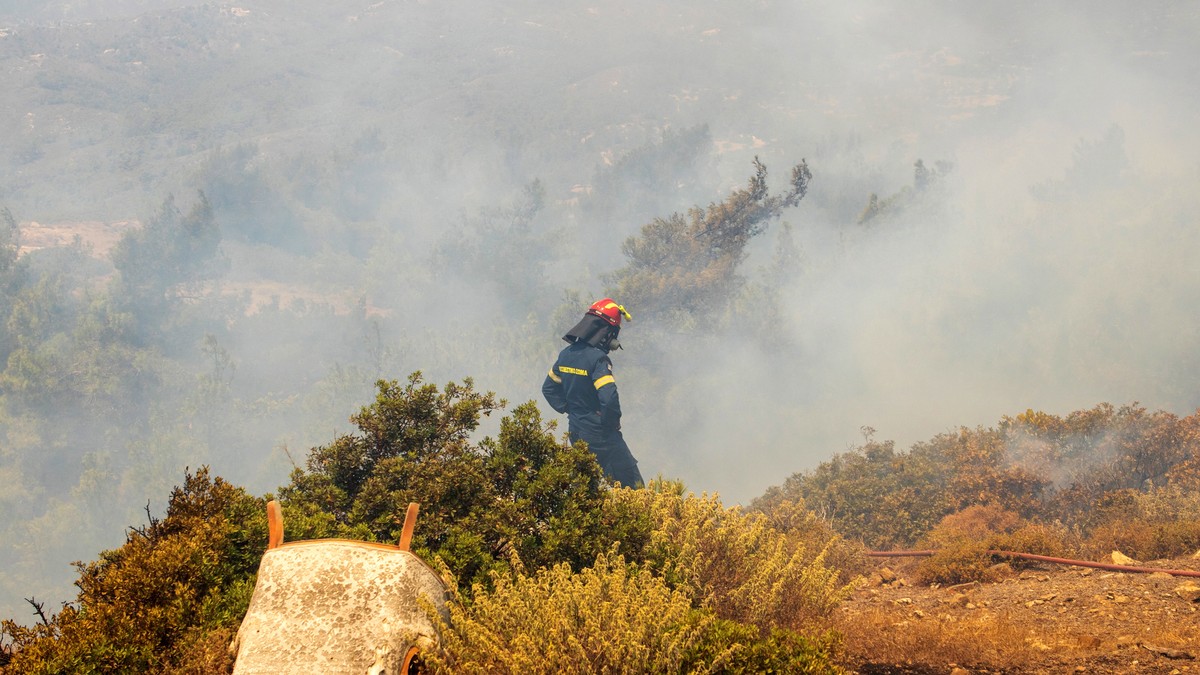epa10764096 A firefighter tries to put out a wildfire in Asklipio village, on Rhodes island, Greece, 23 July 2023. Firefighters battle wildfires on the island of Rhodes burning in three active fronts. ...