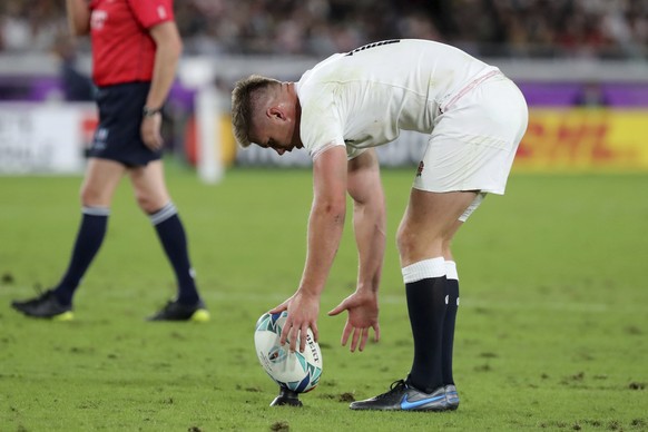 England's Owen Farrell places a ball for a penalty during the Rugby World Cup final between England and South Africa at International Yokohama Stadium in Yokohama, Japan, Saturday, Nov. 2, 2019. (AP Photo/Eugene Hoshiko)