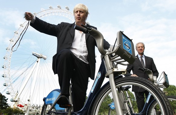 FILE - In this Friday, July 30, 2010 file photo, Boris Johnson, then Mayor of London, left, with the Chairman of Britain&#039;s Barclays Bank Marcus Agius as they poses for the media as a new cycle hi ...