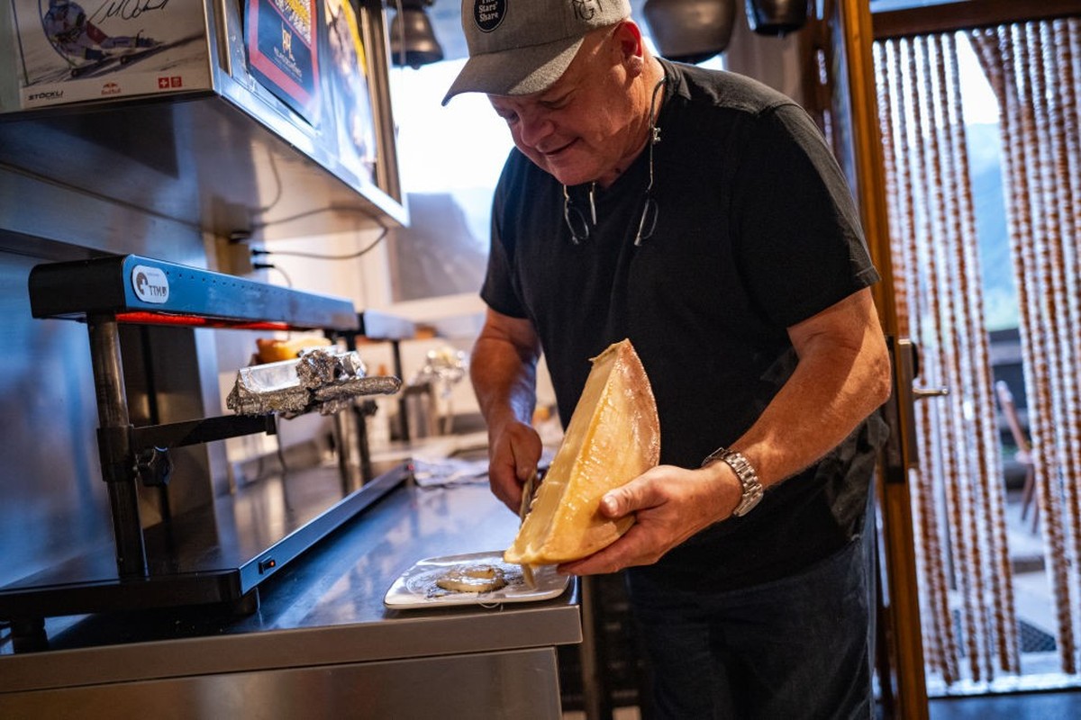BRUSON, SWITZERLAND - JULY 5: Owner Eddy Baillifard serves raclette cheese to customers at the Raclett'House restaurant in Bruson, Switzerland, Friday, July 5, 2024. (Photo by Salwan Georges/The  ...
