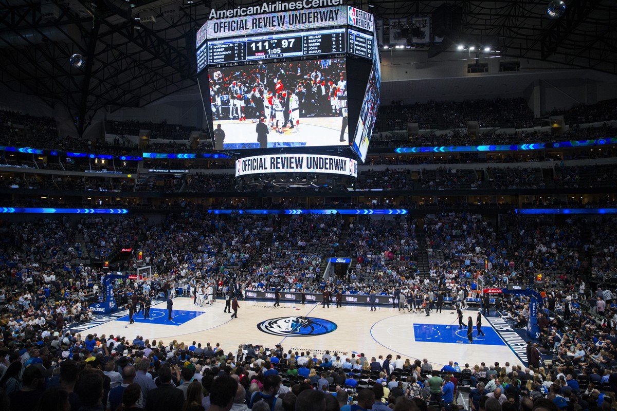 Fans watch the fourth quarter of an NBA game between the Dallas Mavericks and the Denver Nuggets on Wednesday, March 11, 2020 at American Airlines Center in Dallas. The NBA has suspended its season â? ...