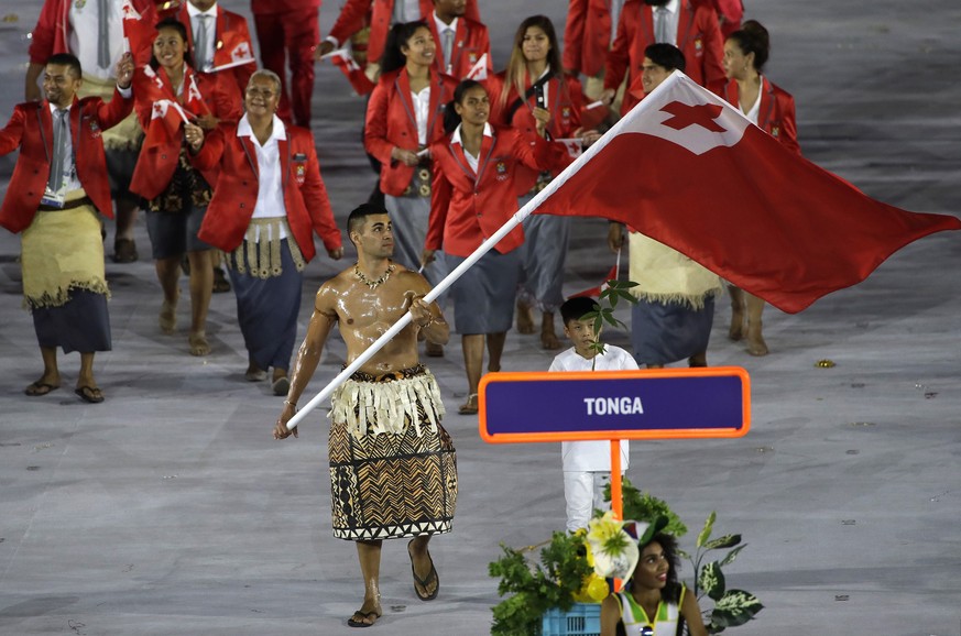 Pita Nikolas Aufatofua carries the flag of Tonga during the opening ceremony for the 2016 Summer Olympics in Rio de Janeiro, Brazil, Friday, Aug. 5, 2016. (AP Photo/Matt Slocum)