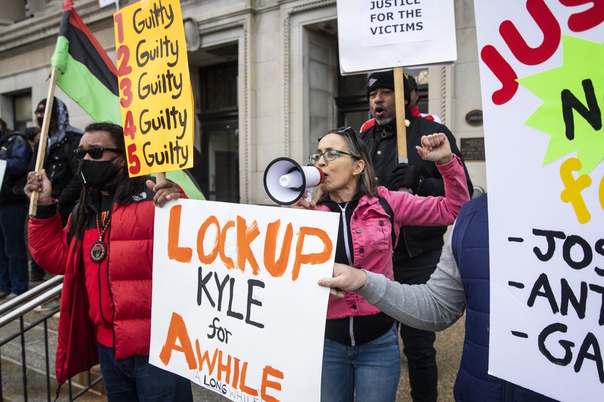 Jacob Blake&#039;s uncle, Justin Blake, left, in red, joins protesters on both sides of the Kyle Rittenhouse case on the steps of the Kenosha County Courthouse while the jury deliberates for the secon ...