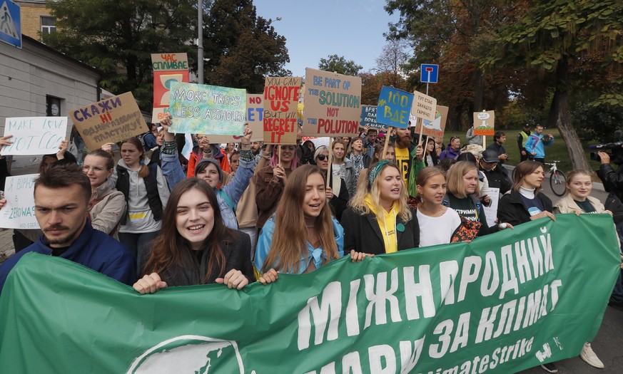 epa07855949 Ukrainians hold placards during the Global Climate strike in Kiev, Ukraine, 20 September 2019. People around the world are taking part in protests demanding action on climate issues. EPA/S ...