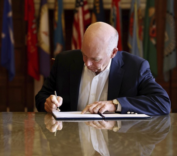 In this photo from the Montana Governor's Office, Republican Gov.  Greg Gianforte signs a law banning TikTok in the state, Wednesday, May 17, 2023, in Helena, Mont.  That law made Montana…