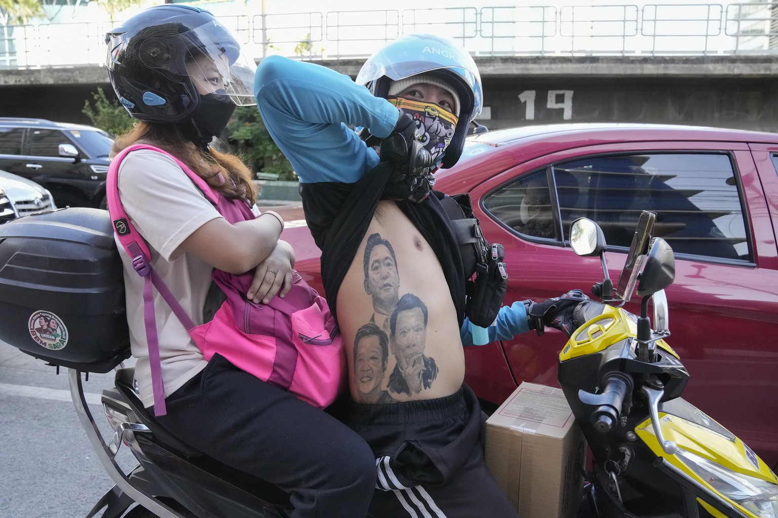 A man displays his tattoos from top; Ferdinand Marcos, Ferdinand &quot;Bongbong&quot; Marcos Jr., and Philippine President Rodrigo Duterte as he passes by BBM headquarters in Mandaluyong, Philippines  ...