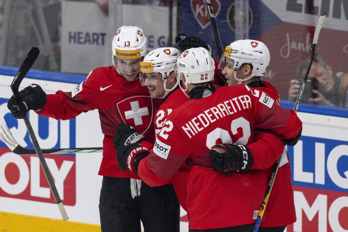 Switzerland's Nico Hischier, Kevin Fiala, Nino Niederreiter, and Philipp Kurashev, from left, celebrate their goal to 1-0 during the Ice Hockey World Championship group A preliminary round match  ...