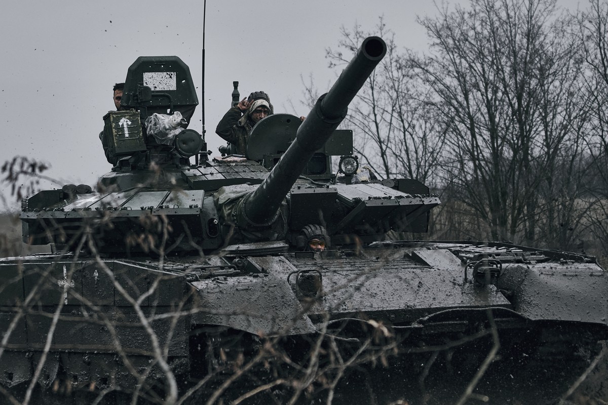 Ukrainian soldiers ride a captured Russian tank in the front line in Donetsk region, Ukraine, Tuesday, Nov. 22, 2022. (AP Photo/LIBKOS)