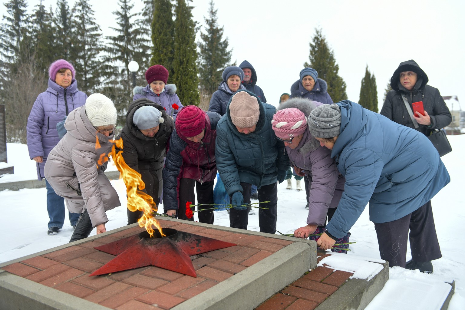 Women lay flowers in memory of those who were killed in the plane on Wednesday, at the memorial to soldiers who died in the Great Patriotic War &quot;Enternal Flame&quot; in Belgorod, Russia, Thursday ...