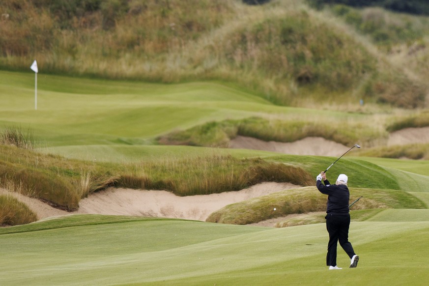 epa12270516 US President Donald J. Trump (L) plays golf after the opening ceremony for the Trump International Golf Links in Balmedie, Scotland, Britain, 29 July 2025. This is the final day of the pri ...