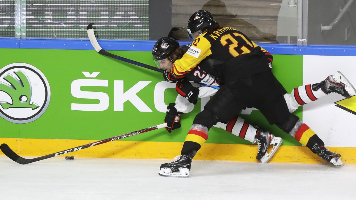 Canada's Brandon Hagel, left, challenges for the puck with Germany's Nikolas Krammer during the Ice Hockey World Championship group B match between Germany and Canada at the Arena in Riga, L ...