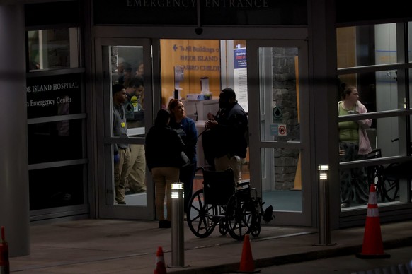 People stand at an entrance to Rhode Island Hospital in Providence, R.I., on Saturday, Dec. 13, 2025, where victims from a shooting at Brown University were transported. (AP Photo/Mark Stockwell)
Brow ...
