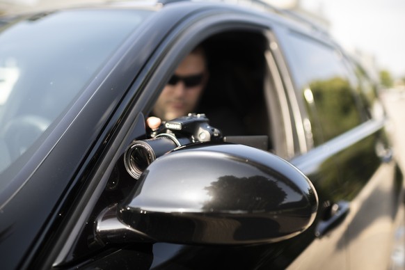 [Symbolic Image, Staged Picture] A professional private detective of the detective agency investigo takes pictures from inside his car, pictured in Otelfingen, Canton of Zurich, Switzerland, on June 8 ...