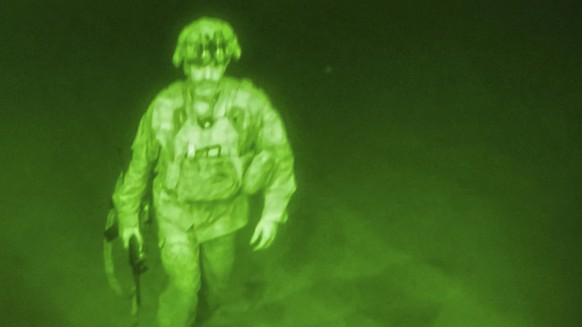 In this image made through a night vision scope and provided by U.S. Central Command, Maj. Gen. Chris Donahue, commander of the U.S. Army 82nd Airborne Division, XVIII Airborne Corps, boards a C-17 ca ...
