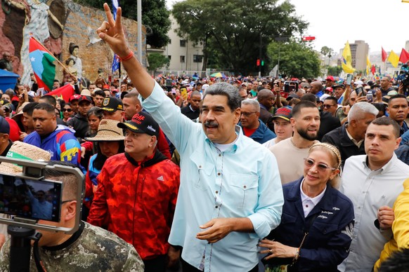 President Nicolas Maduro joins a rally marking the anniversary of the Battle of Santa Isabel, which took place during Venezuela's 19th-century Federal War, in Caracas, Venezuela, Wednesday, Dec.  ...